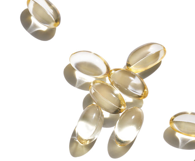 Eight vitamin capsules on a white background. 