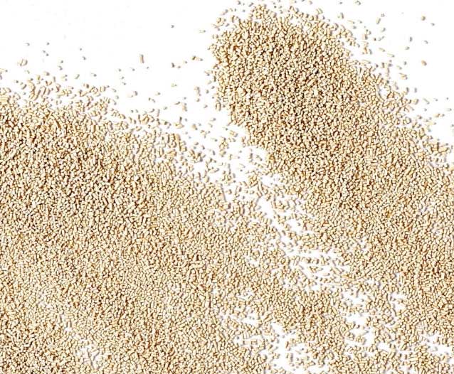 A pile of brown rice powder on a white background