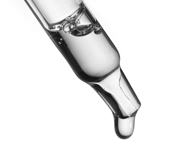 Close up of glass dropper with lactid acid. 