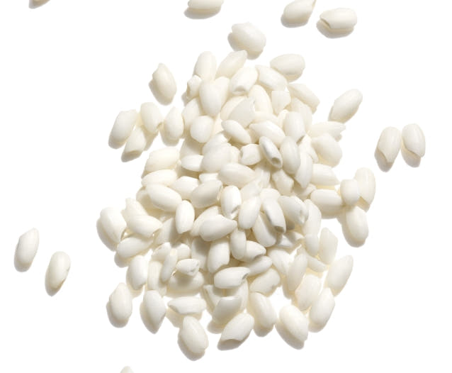 Pile of white rice on a white background. 
