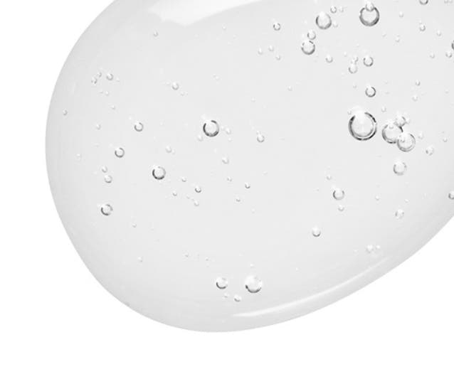 Clear drop of salicylic acid on a white background.