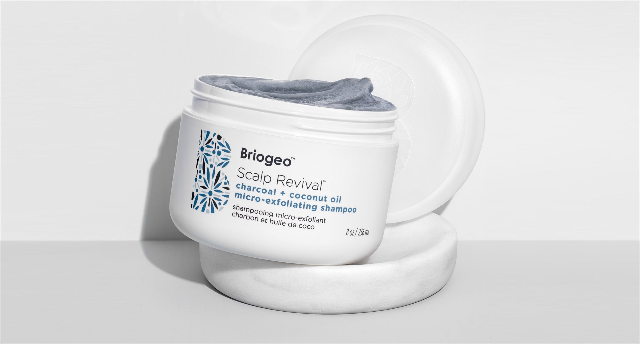 Scalp Revival micro-exfoliating shampoo on white background with instructions to Rinse lid, liner and base and recycle at home. 