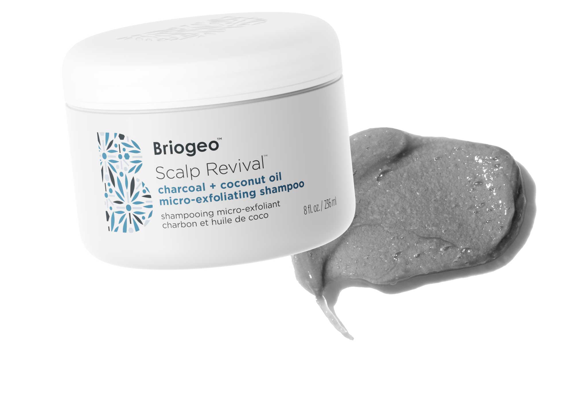 Briogeo Scalp Revival Exfoliating Scalp Scrub in front of a grey, whipped textured swatch. 